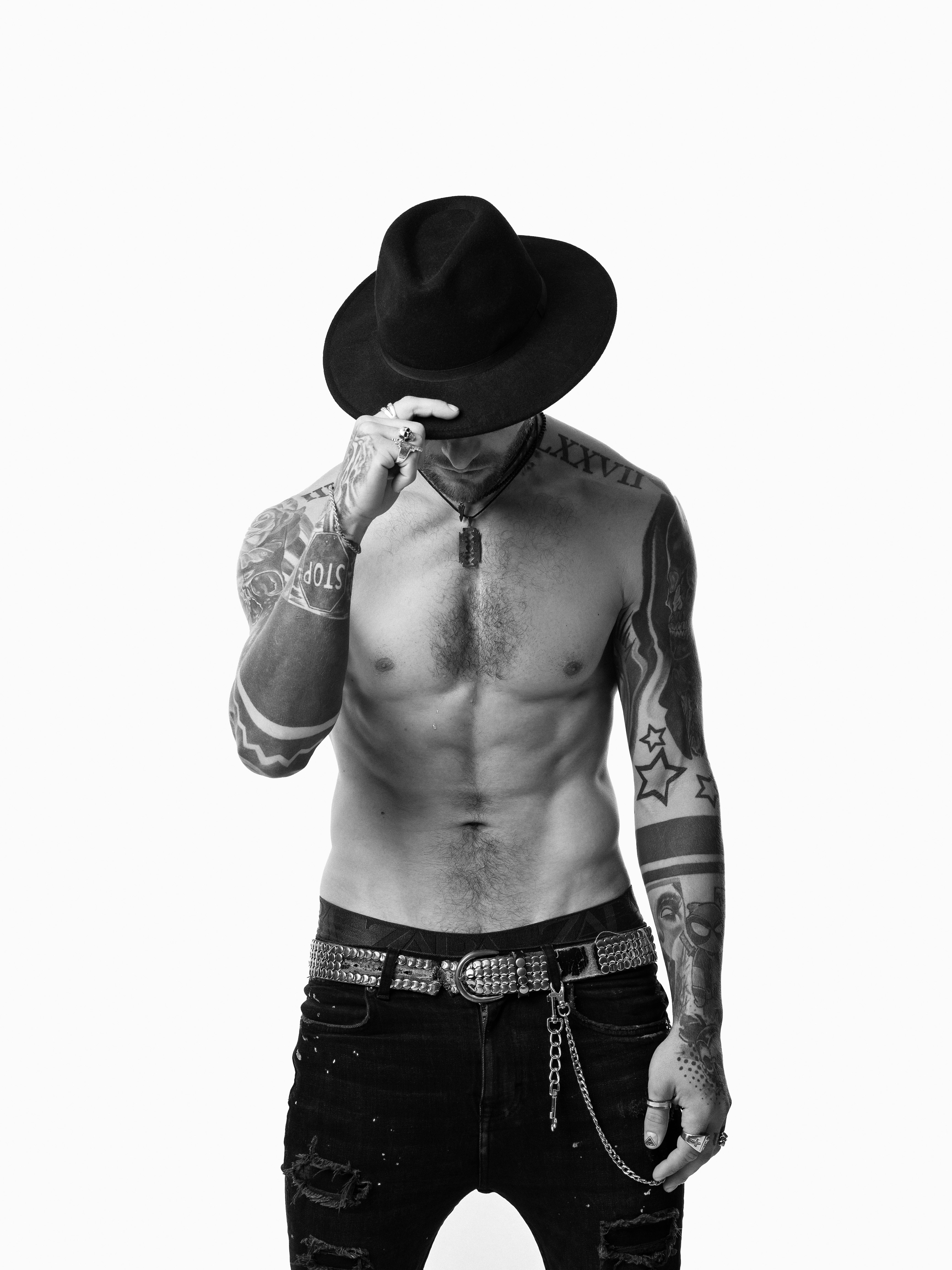 topless man wearing cowboy hat